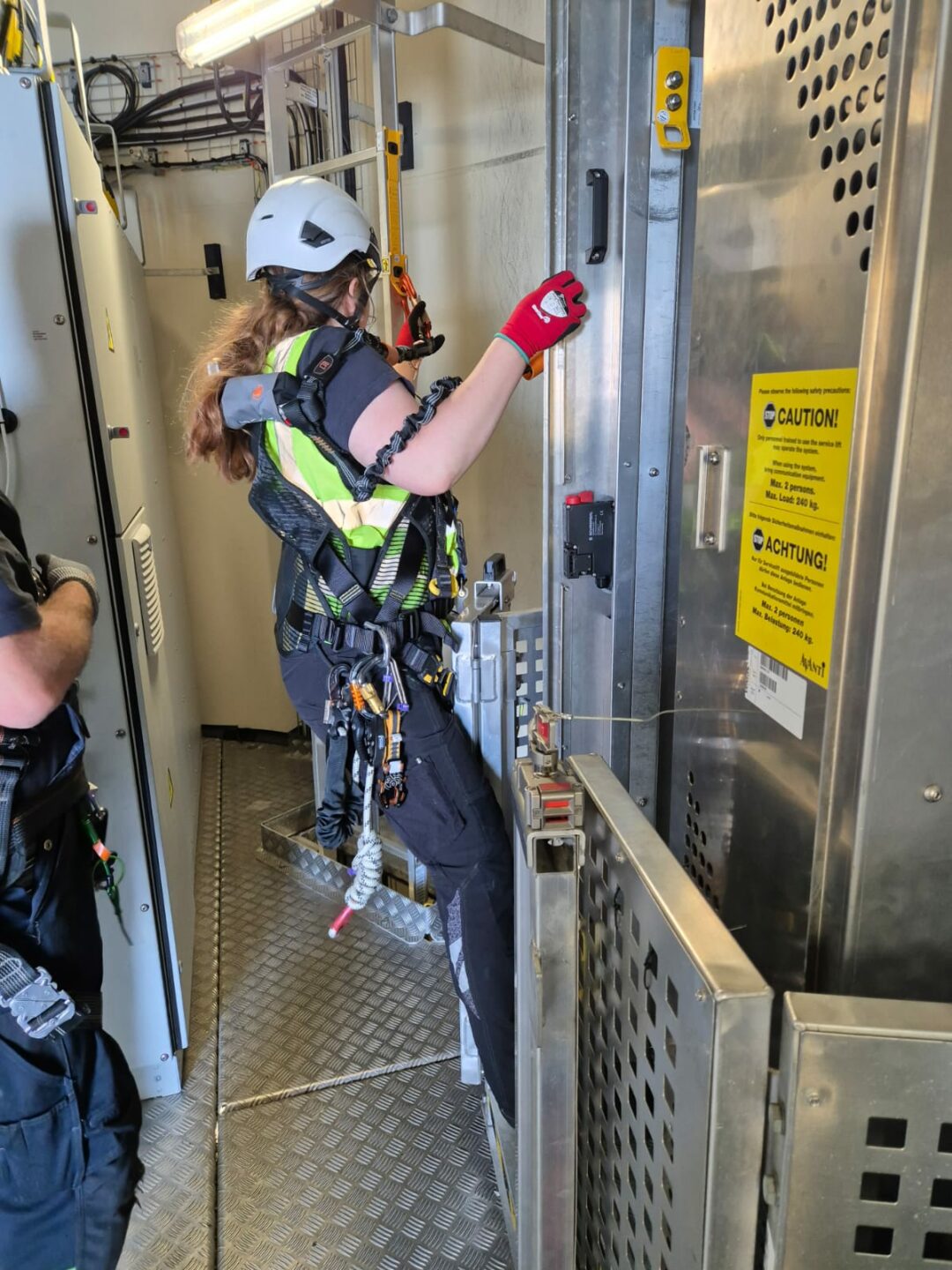 Madeleine is shown at work. She is wearing safety gear.