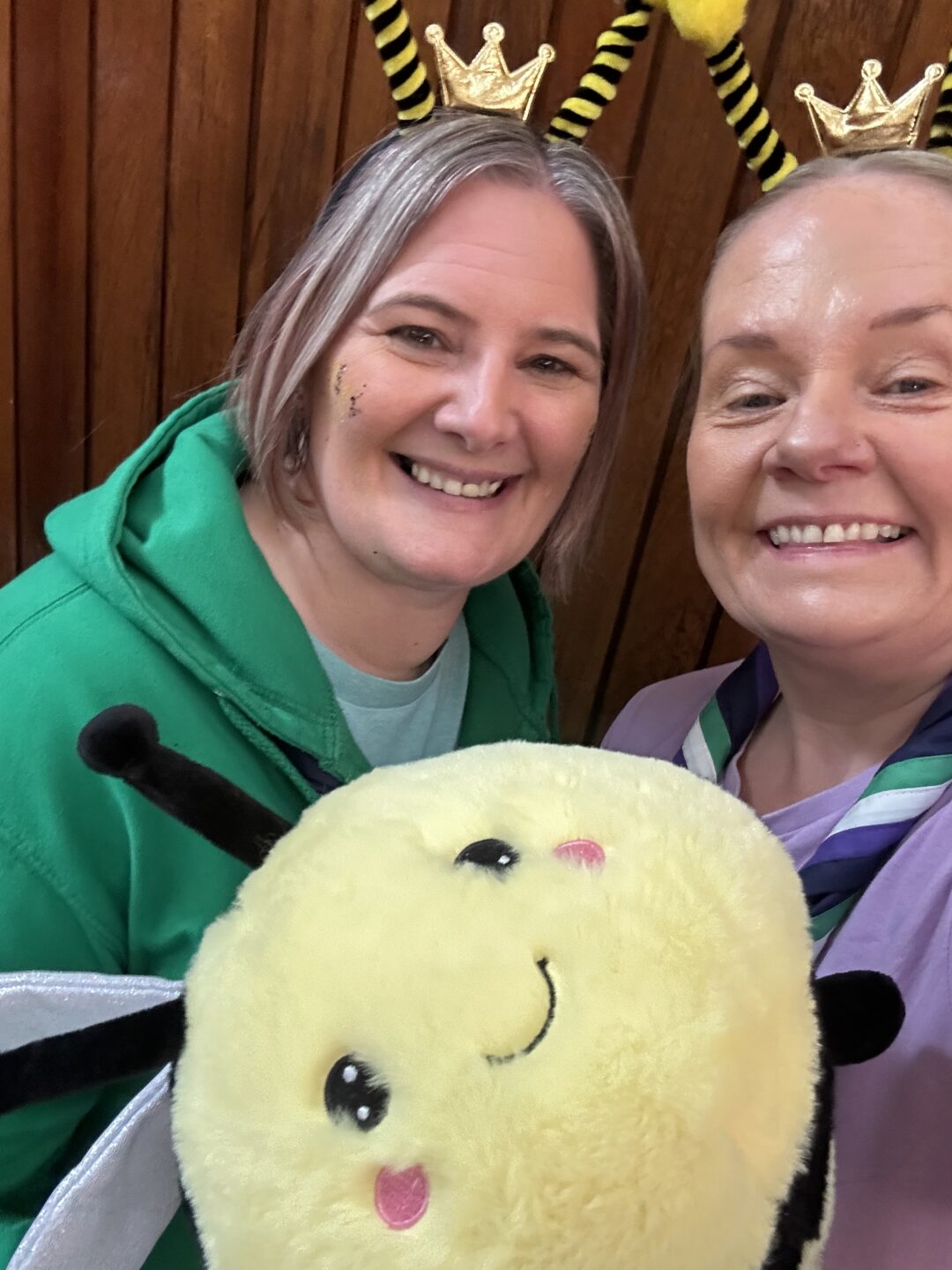Image shows Tracey and Kelly Hunter. They are smiling and holding a big Bee toy