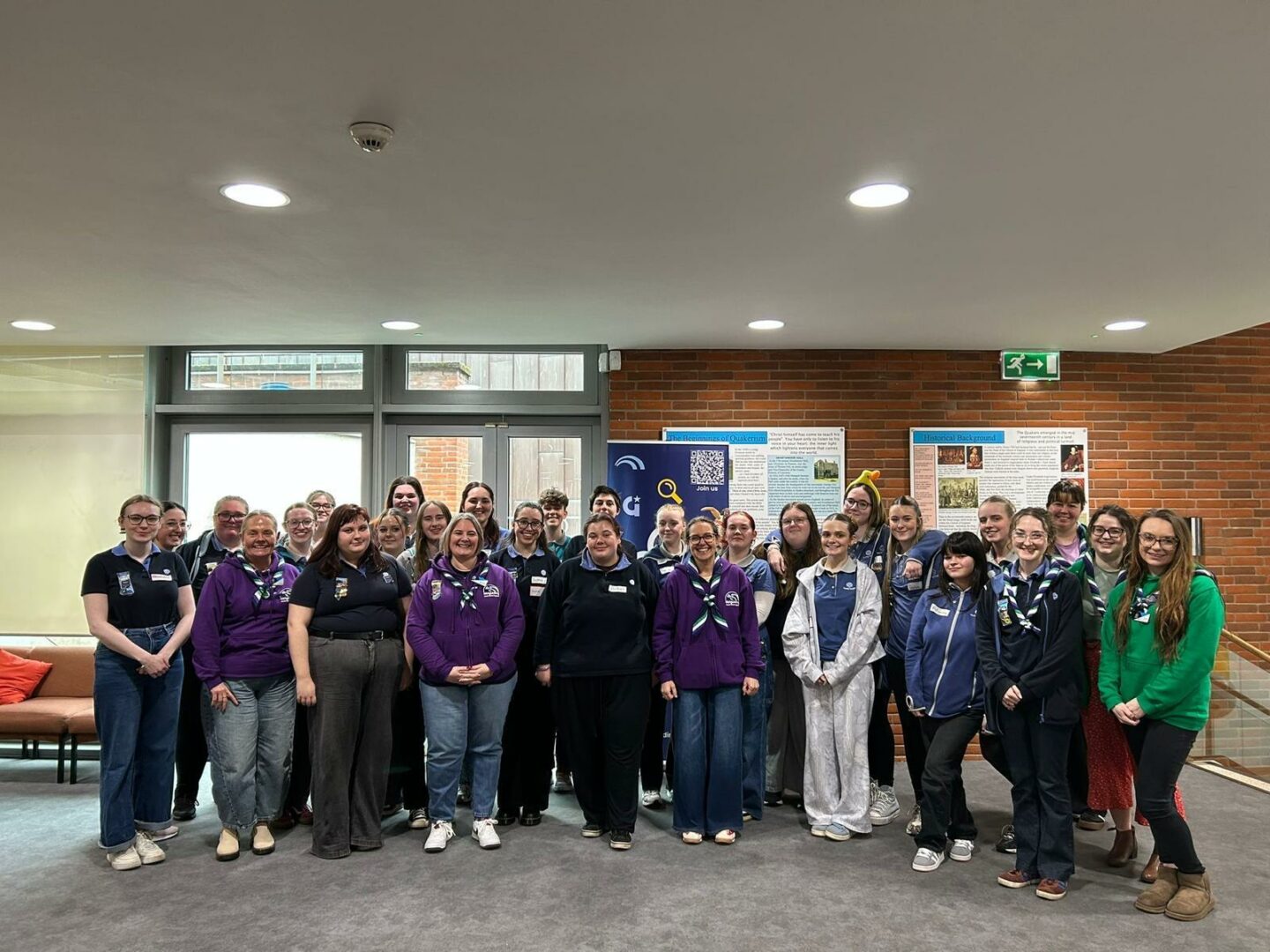 Image shows all attendees of the Youth Voice Conference congregated and smiling at the camera