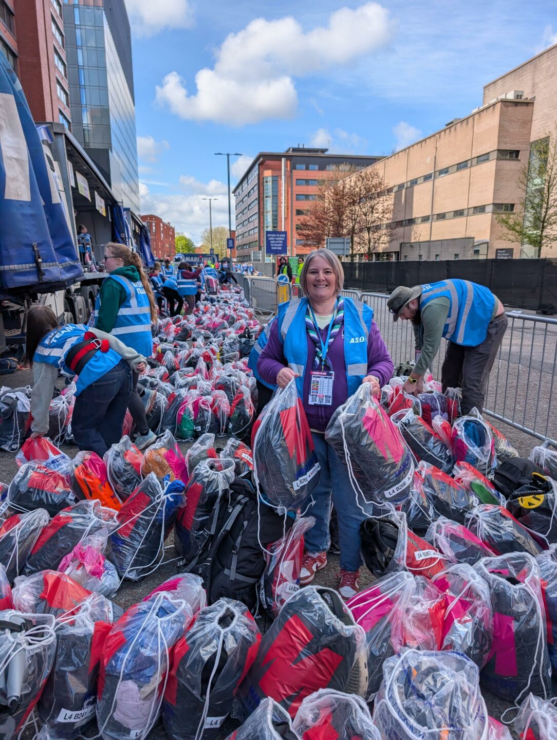 Chiefs at Work - Tracey helps to hand out bags at the finish line of Manchester Marathon - April 2026